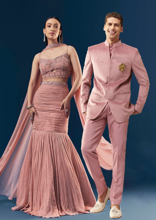 Celebration Couple Set – Blush Pink Georgette Fish-Cut Lehenga with Embroidered Sleeveless Blouse & Choker Dupatta for Her And Pink Jodhpuri-Style Tuxedo Set with Metal Broach for Him