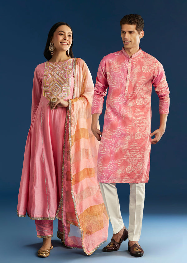 Soft Festive Couple Set – Pink Muslin Gotta Work Anarkali With Pant And Dupatta For Her And Pink Floral Print Art Silk Kurta Pant Set For Him