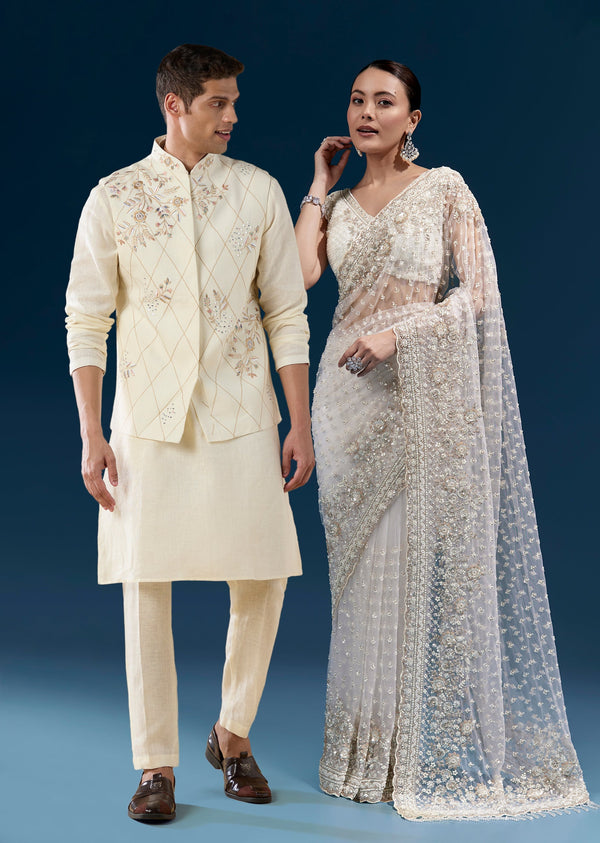 Soft Glow Couple Set – Off-White Heavy Embroidered Net Saree For Her And Cream Art Silk Jacket Kurta Set For Him