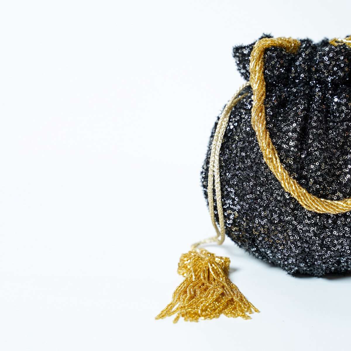 black_potli_bag_in_sequins_fabric_with_cut_dana_tassels_and_handle_by_solasta_1_97141dfb-c642-4d86-a5f5-a53837a447b1.jpg