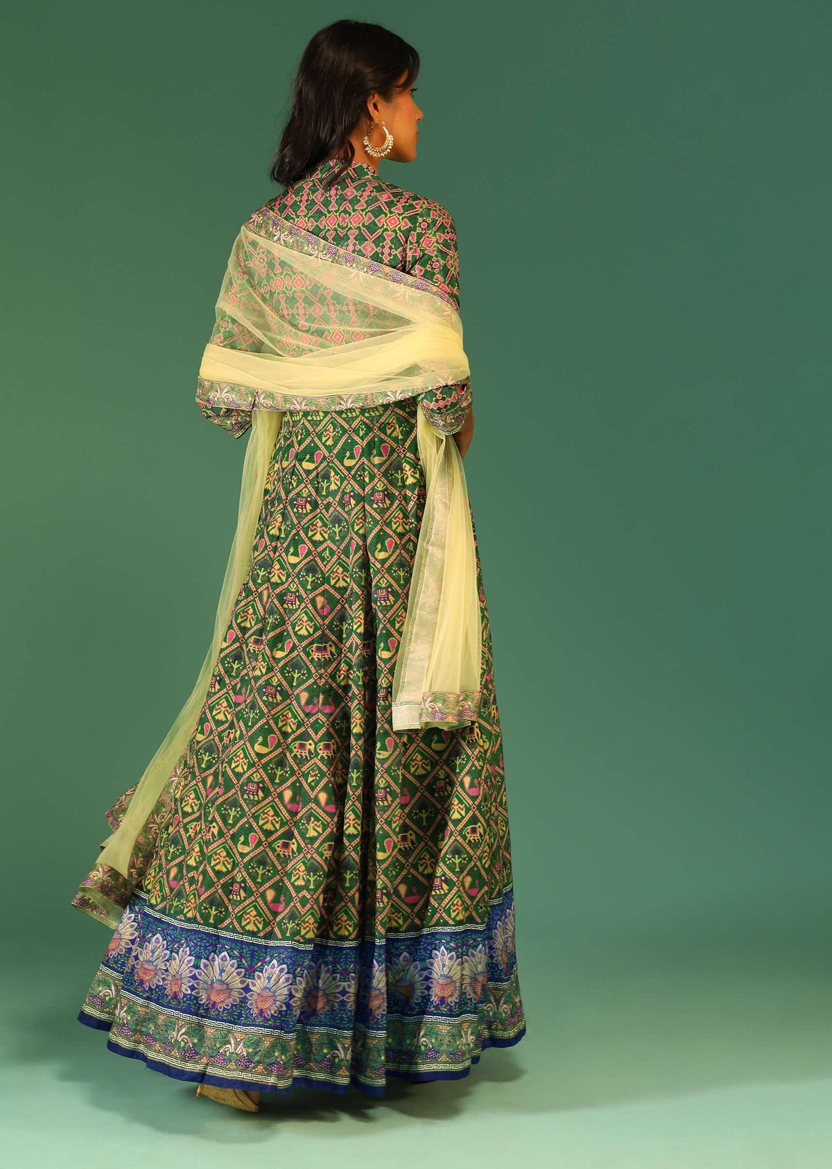 bottle_green_anarkali_suit_in_raw_silk_with_patola_print_and_kundan_detailing_along_with_a_yellow_net_dupatta_online_-_kalki_fashion_5_1_e53529af-96dc-4247-ba74-1c87fd3edac8.jpg