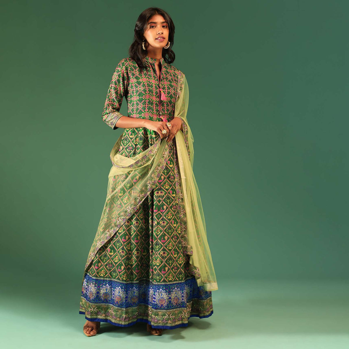 bottle_green_anarkali_suit_in_raw_silk_with_patola_print_and_kundan_detailing_along_with_a_yellow_net_dupatta_online_-_kalki_fashion_5_2_c21c954e-cc54-4884-8d49-198efafbd0ff.jpg