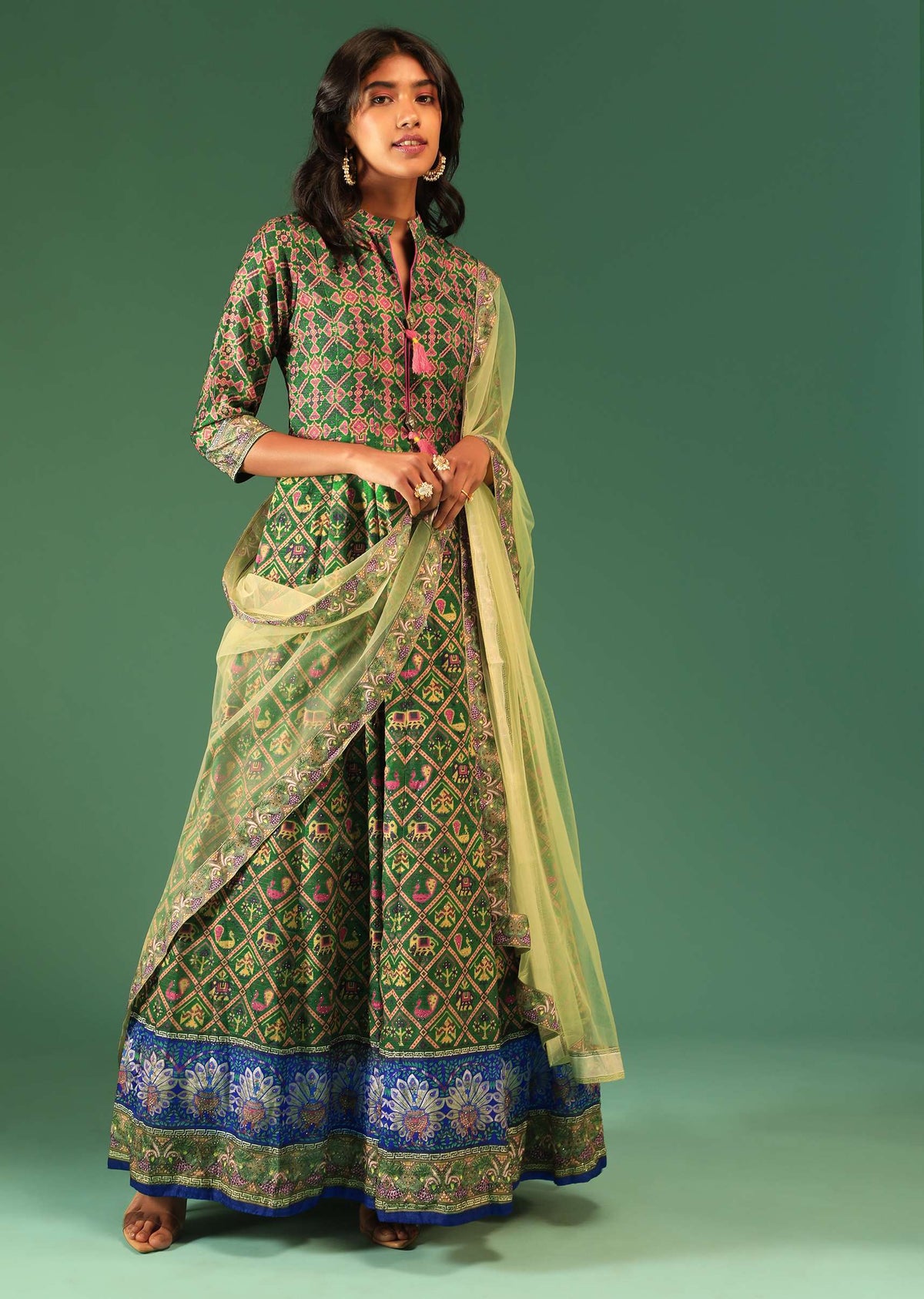 bottle_green_anarkali_suit_in_raw_silk_with_patola_print_and_kundan_detailing_along_with_a_yellow_net_dupatta_online_-_kalki_fashion_5_3_293aa6fd-7135-4ade-b8d2-c550ac415a9d.jpg