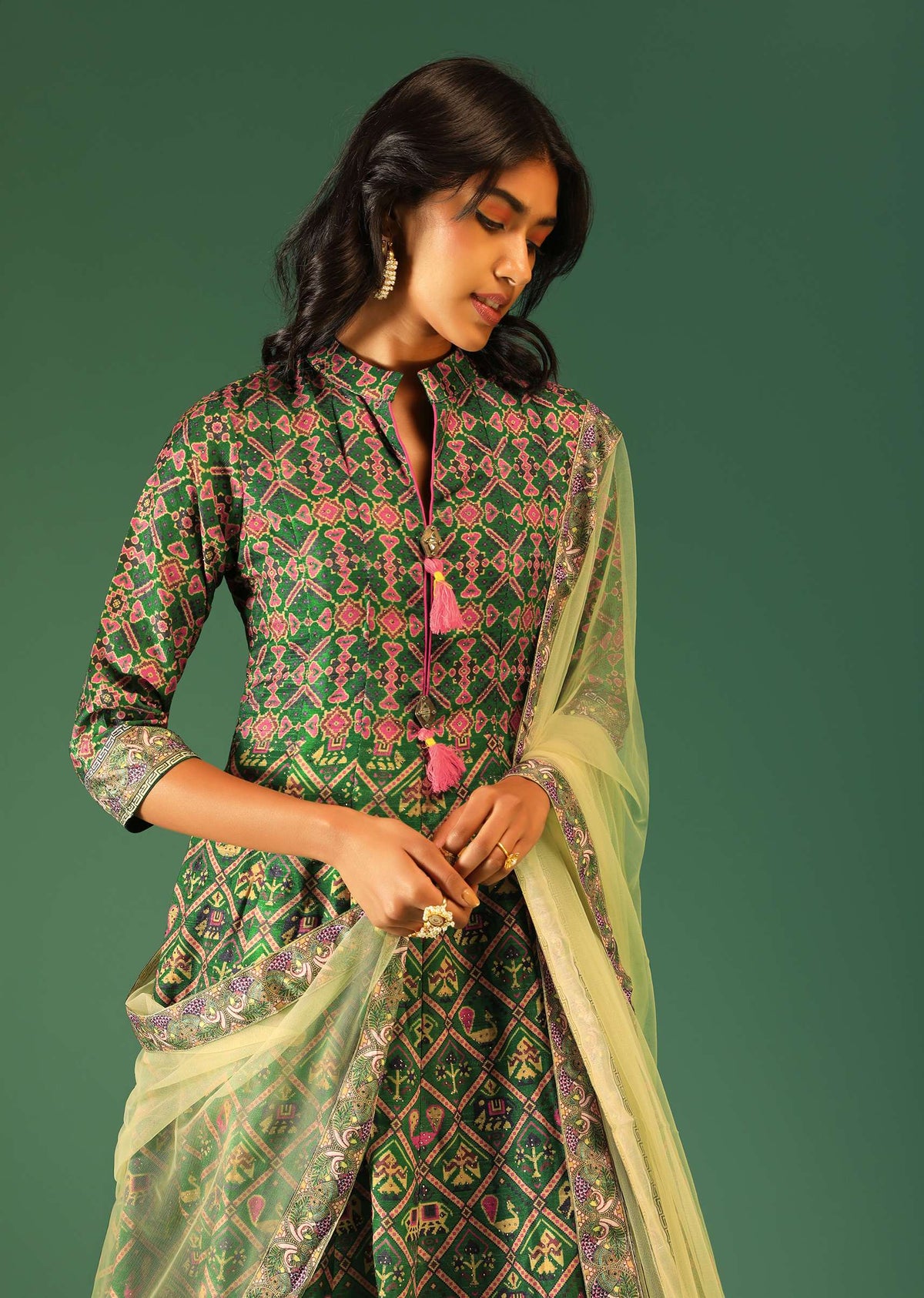 bottle_green_anarkali_suit_in_raw_silk_with_patola_print_and_kundan_detailing_along_with_a_yellow_net_dupatta_online_-_kalki_fashion_5_4_a32e959f-7c15-420b-b7dc-9d9134c6e928.jpg