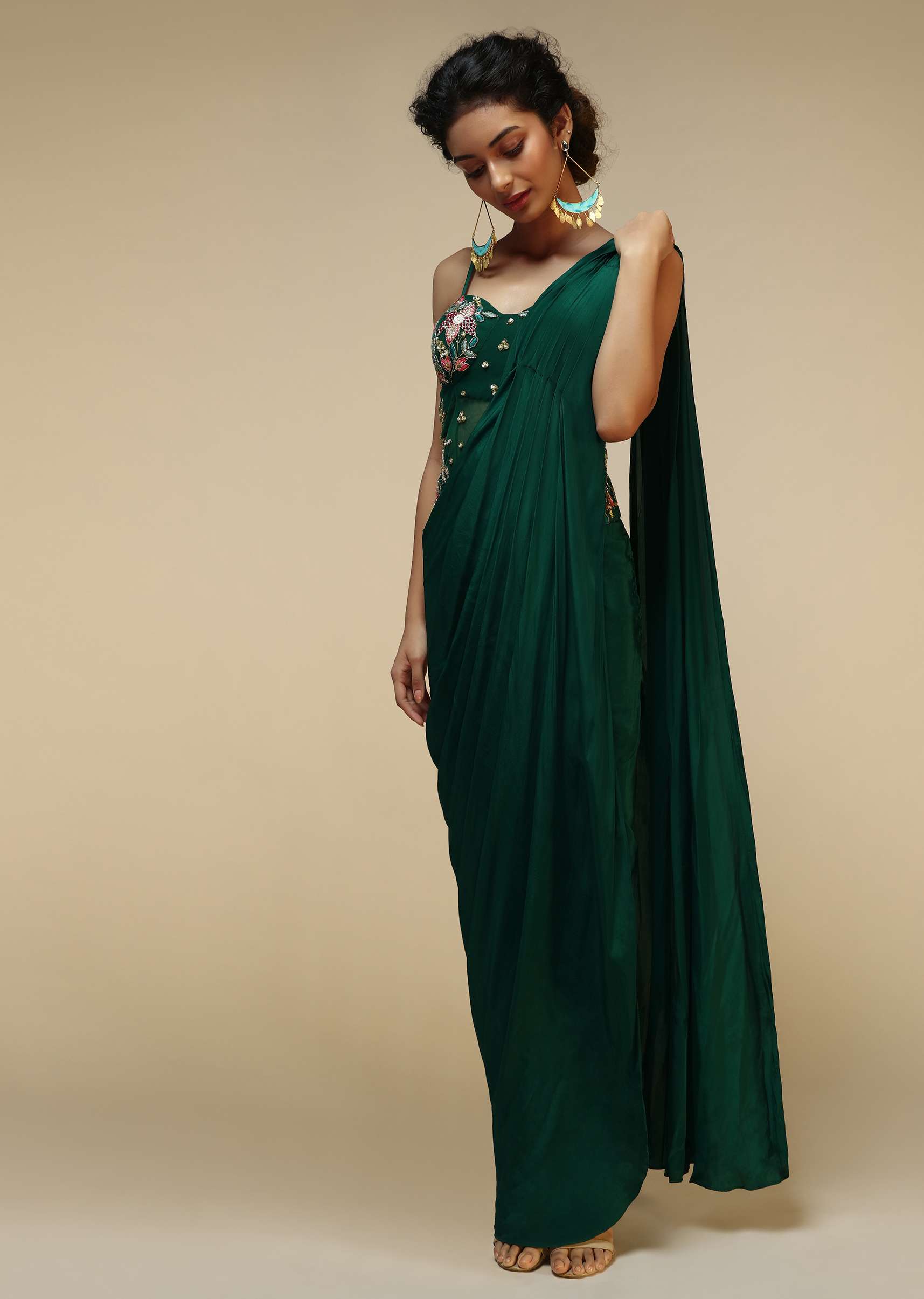 bottle_green_saree_gown_with_a_crepe_cowl_drape_and_sheer_embroidered_net_bodice_with_colorful_resham_flowers_online_-_kalki_fashion_1_2_8659f341-e30b-453d-8a37-62f0a0cc3aaa.jpg