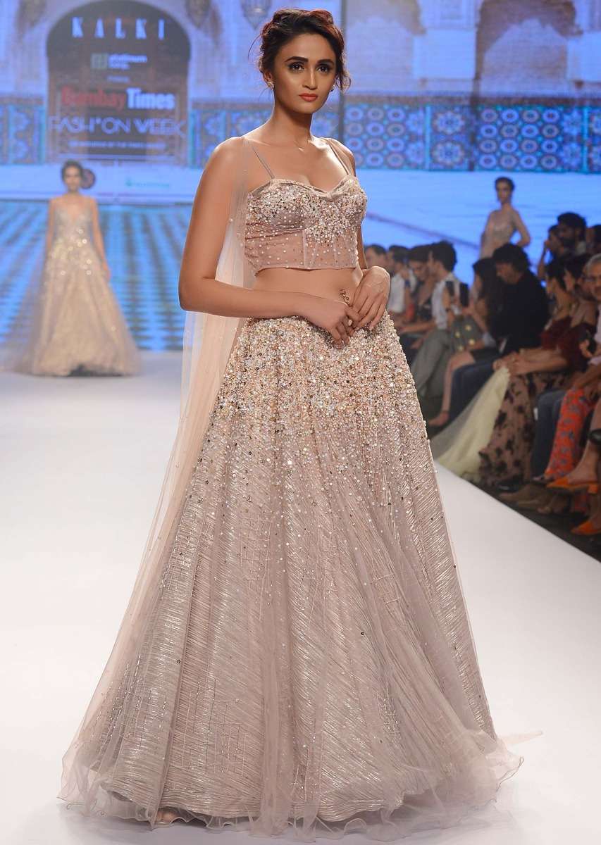 dusty-pink-lehenga-paired-with-multi-paneled-corset-blouse-with-attached-net-drape-only-on-kalki-460501_bf35770f-6a67-4b05-a668-0dde5d18cc77.jpg