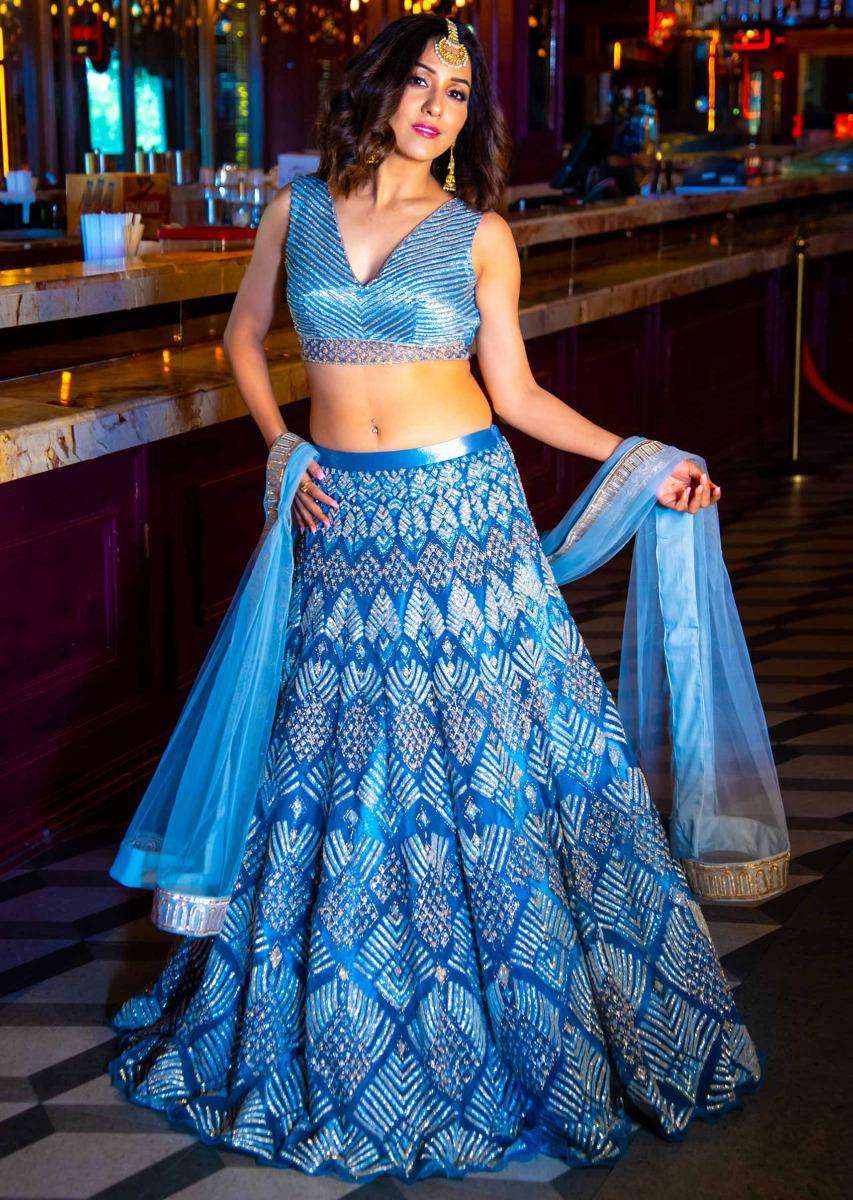 neeti_mohan_in_kalki_iris_blue_net_lehenga_and_blouse_with_attached_net_drape_with_side_slits_2_8794b8d0-ba75-49a4-b030-ba6dff881be4.jpg