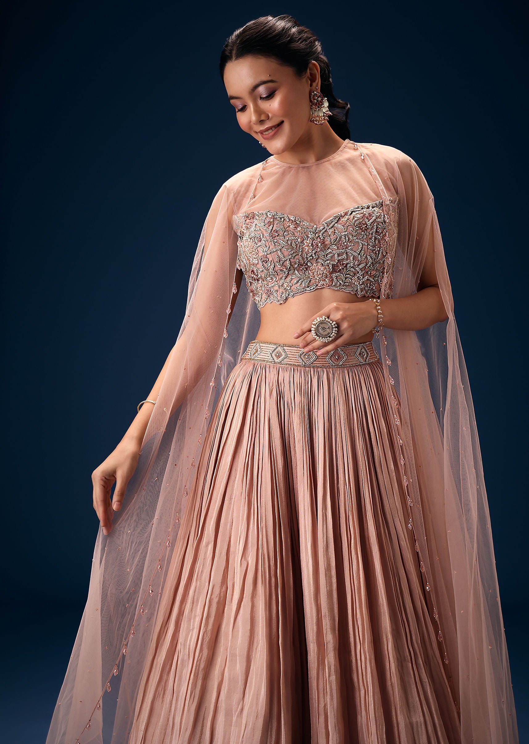 peach_ruched_lehenga_with_embroidered_blouse_and_net_cape-sg251638_5_d35808a3-9f06-4562-bcb7-61eb94ed9efe.jpg