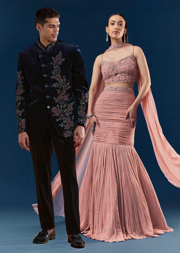 Velvet And Pastel Glamour Couple Set – Blush Pink Fish Cut Lehenga for Her And Blue Velvet Jodhpuri Set for Him