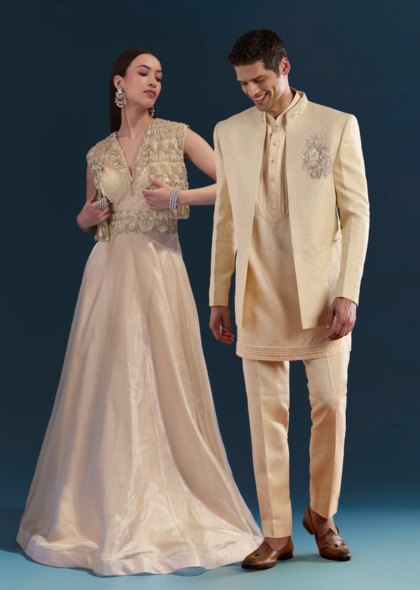 Gold Celebration Duo – Jumpsuit With Jacket For Her And Embellished Jodhpuri Kurta Set For Him